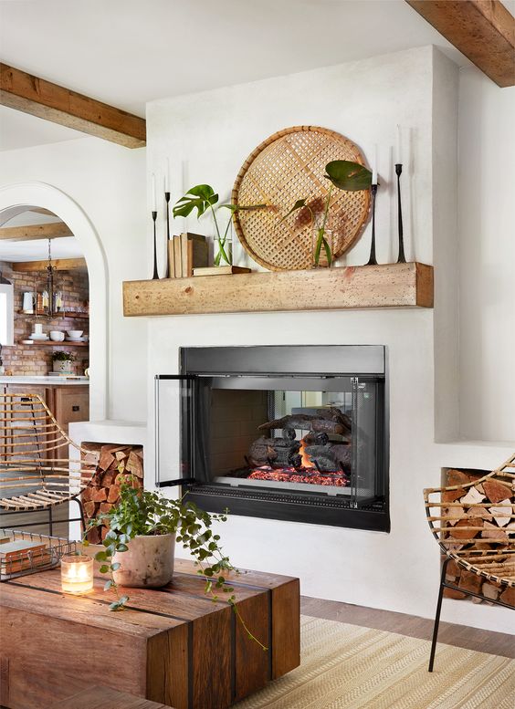 Living room by Joanna Gaines with double-sided fireplace and rustic exposed brick in this Jackson home 